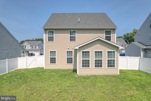 back of house with a lawn