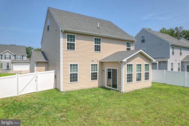 rear view of house featuring a yard