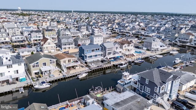 drone / aerial view with a residential view and a water view