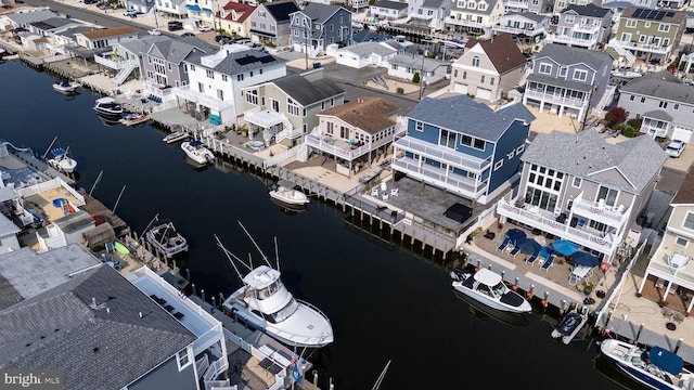 drone / aerial view featuring a residential view and a water view