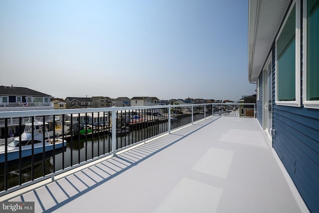 balcony featuring a water view and a residential view