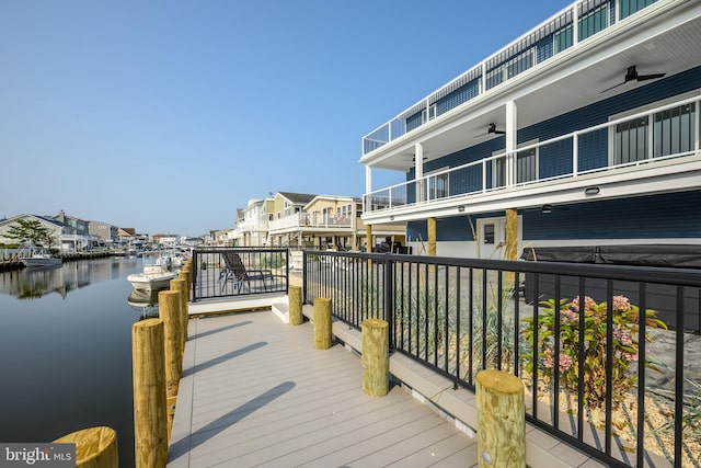 view of dock featuring a residential view and a water view