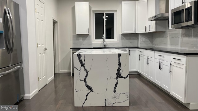 kitchen with dark hardwood / wood-style floors, white cabinetry, wall chimney exhaust hood, backsplash, and stainless steel appliances