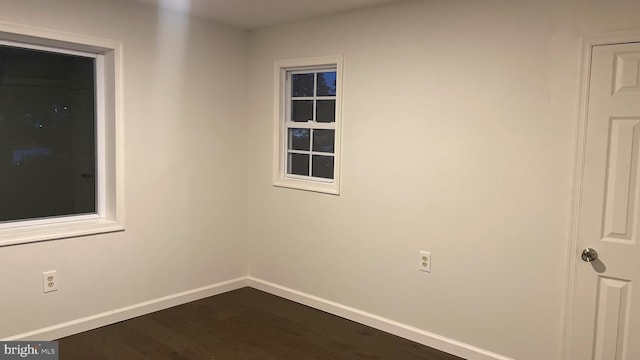 spare room featuring dark hardwood / wood-style floors