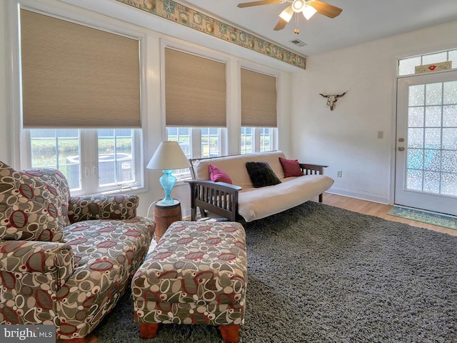 living room with hardwood / wood-style floors and ceiling fan