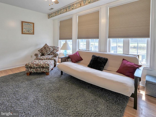 living room featuring ceiling fan and light hardwood / wood-style flooring