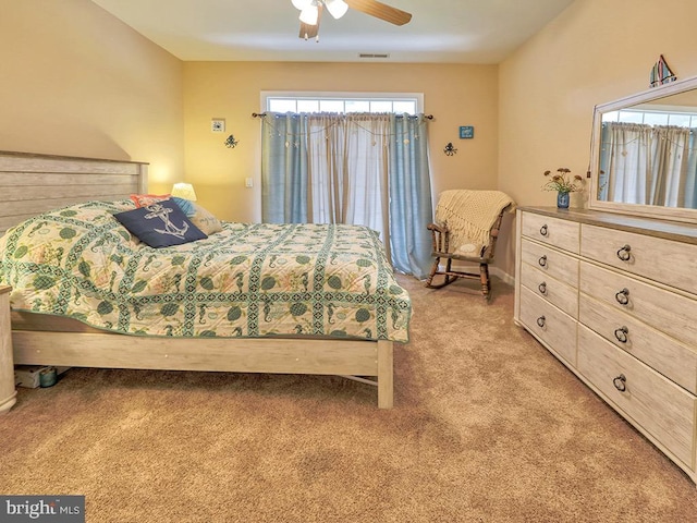 bedroom with ceiling fan and light carpet