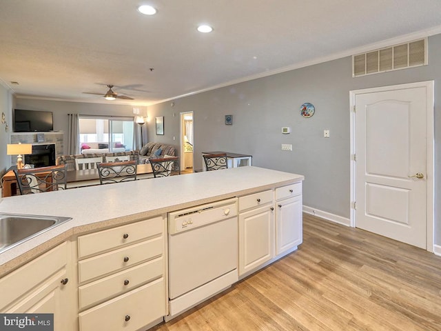 kitchen featuring light wood-type flooring, ornamental molding, ceiling fan, and white dishwasher