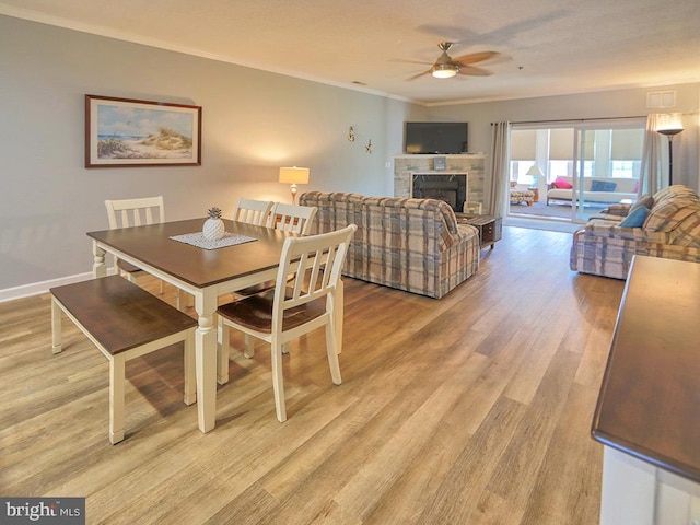 dining area with ceiling fan, ornamental molding, and light hardwood / wood-style floors