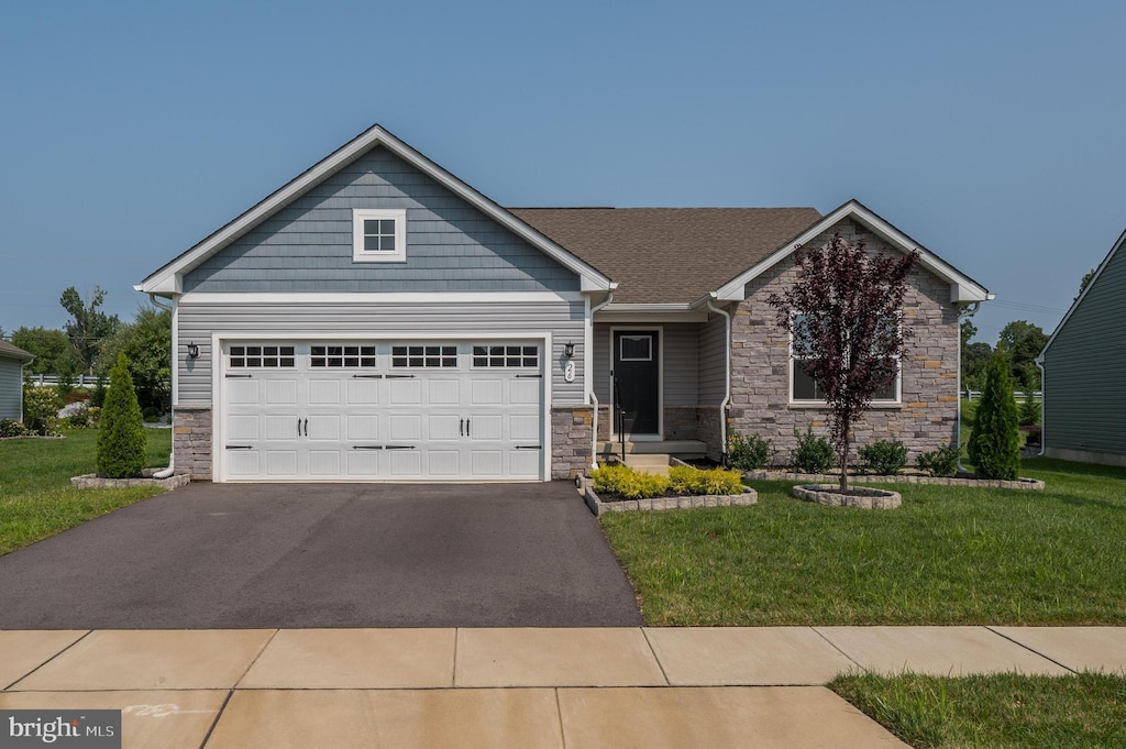 view of front of house featuring a garage and a front lawn