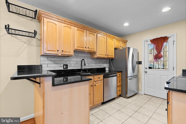 kitchen with decorative backsplash, light tile patterned floors, sink, and appliances with stainless steel finishes