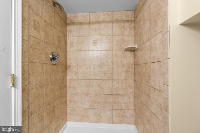 bathroom with a tile shower