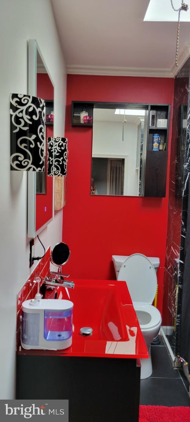 interior space with tile patterned floors, vanity, and toilet