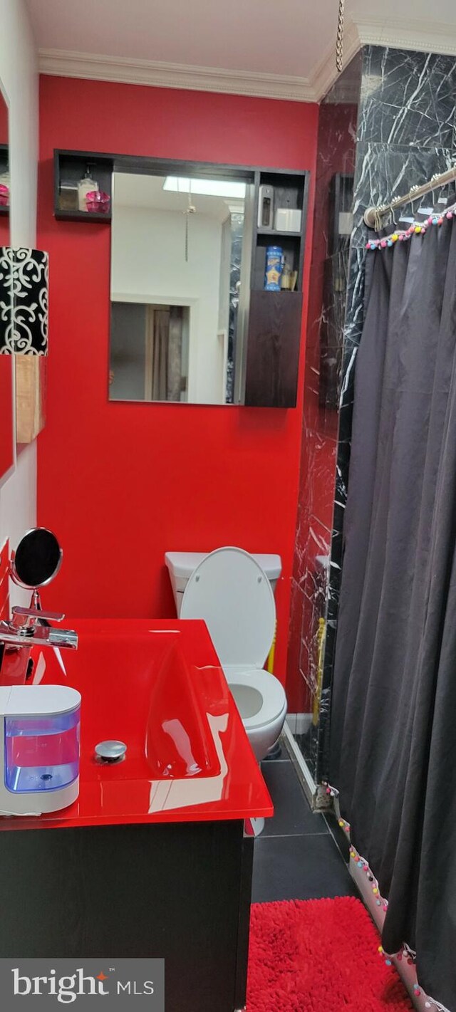 bathroom featuring ornamental molding, vanity, tile patterned flooring, and toilet