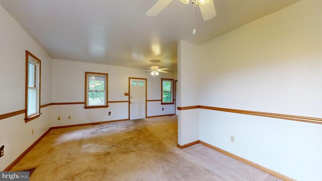 carpeted spare room with ceiling fan and a healthy amount of sunlight