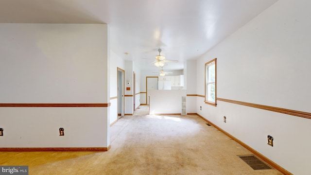 carpeted empty room with ceiling fan