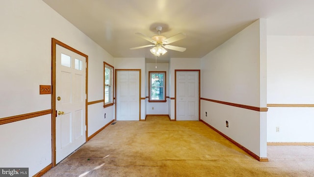 carpeted empty room with ceiling fan