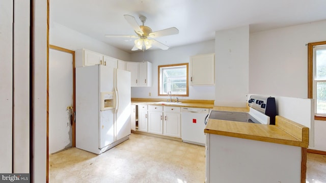 kitchen with ceiling fan, sink, white appliances, and white cabinets