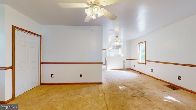 spare room with light colored carpet and ceiling fan