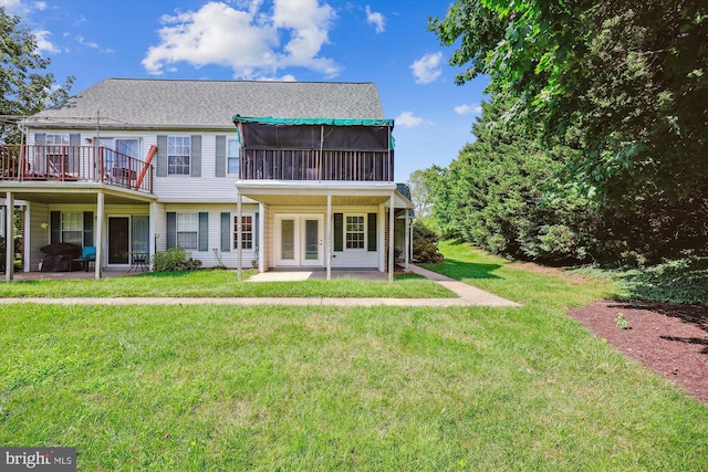 back of property with a lawn and a patio area