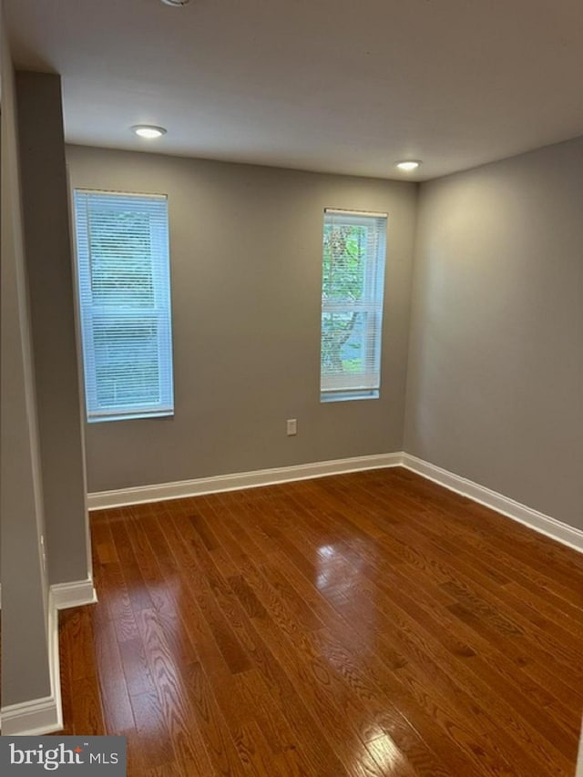 unfurnished room featuring hardwood / wood-style floors