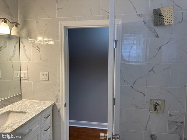 bathroom with vanity, tile walls, and hardwood / wood-style flooring