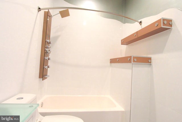 full bathroom with toilet, tiled shower / bath combo, and vanity