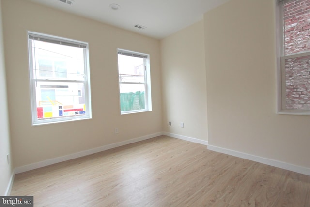 unfurnished room featuring light hardwood / wood-style floors