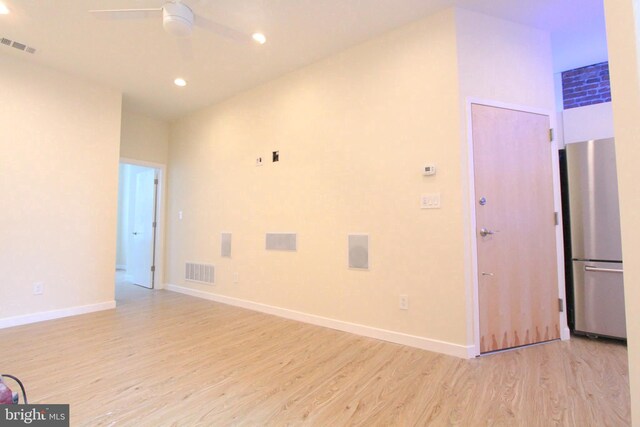 spare room with ceiling fan and light hardwood / wood-style flooring