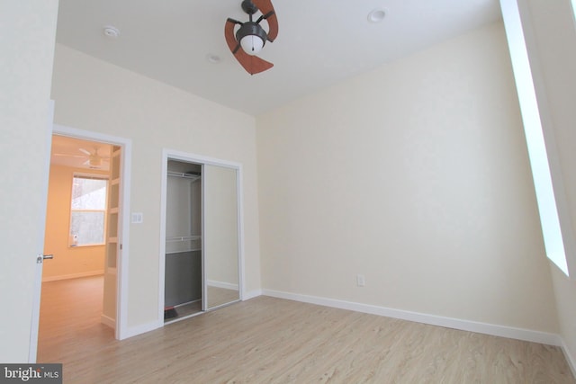 unfurnished bedroom with light hardwood / wood-style floors and a closet