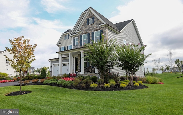 view of front of property featuring a garage and a front lawn