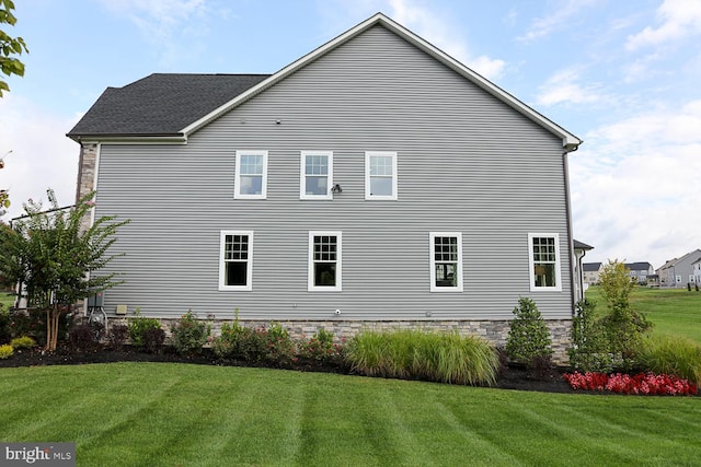 view of home's exterior with a lawn