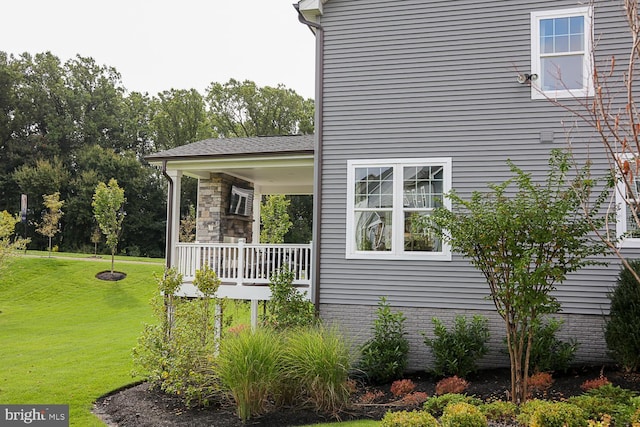 view of side of home featuring a yard