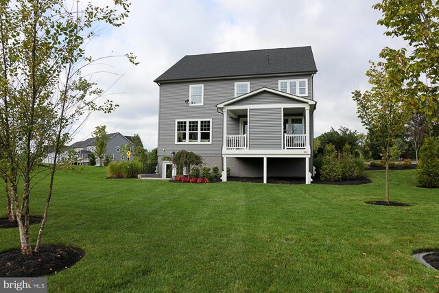 rear view of property with a yard