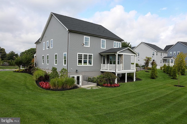 rear view of house featuring a yard