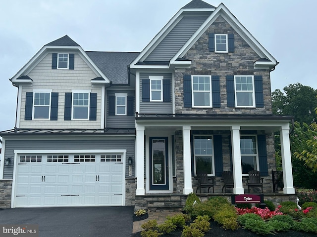 craftsman-style house with a porch and a garage