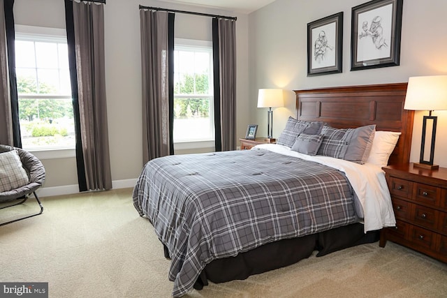 bedroom featuring light carpet