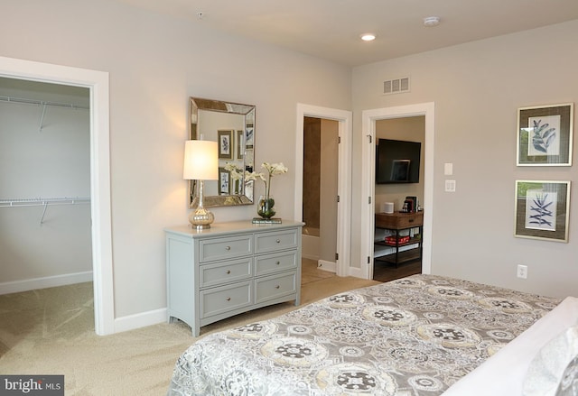 carpeted bedroom featuring a closet and a spacious closet