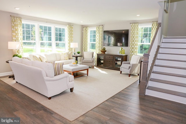 living room featuring dark wood-type flooring and plenty of natural light