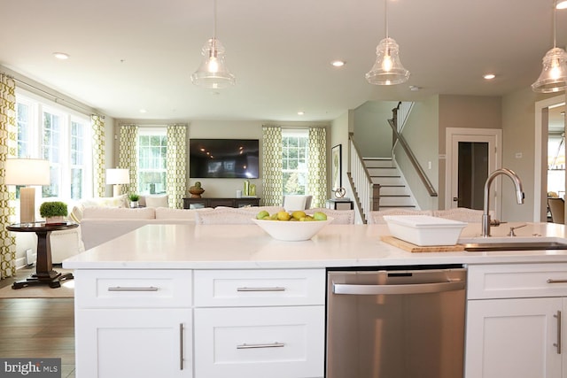 kitchen featuring dark wood-type flooring, dishwasher, a wealth of natural light, and sink