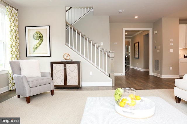 sitting room featuring dark wood-type flooring and ornamental molding