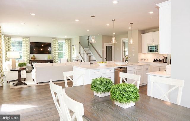 dining area featuring wood-type flooring and sink