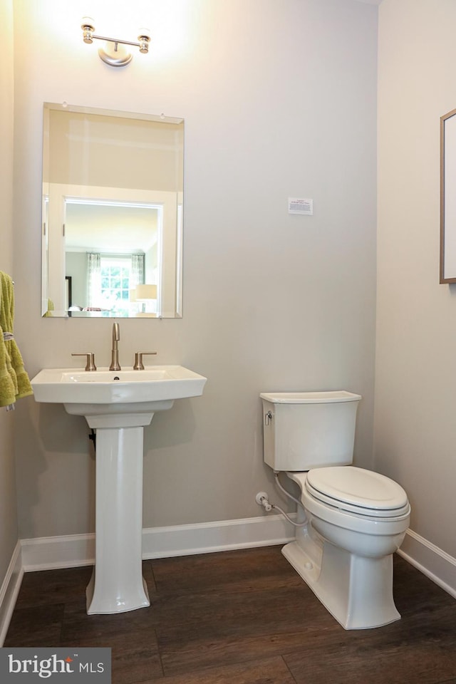 bathroom with wood-type flooring and toilet