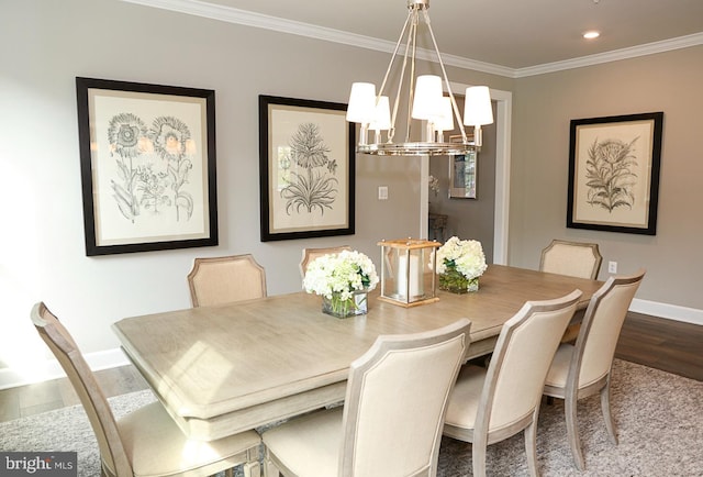 dining area with crown molding, an inviting chandelier, and wood-type flooring