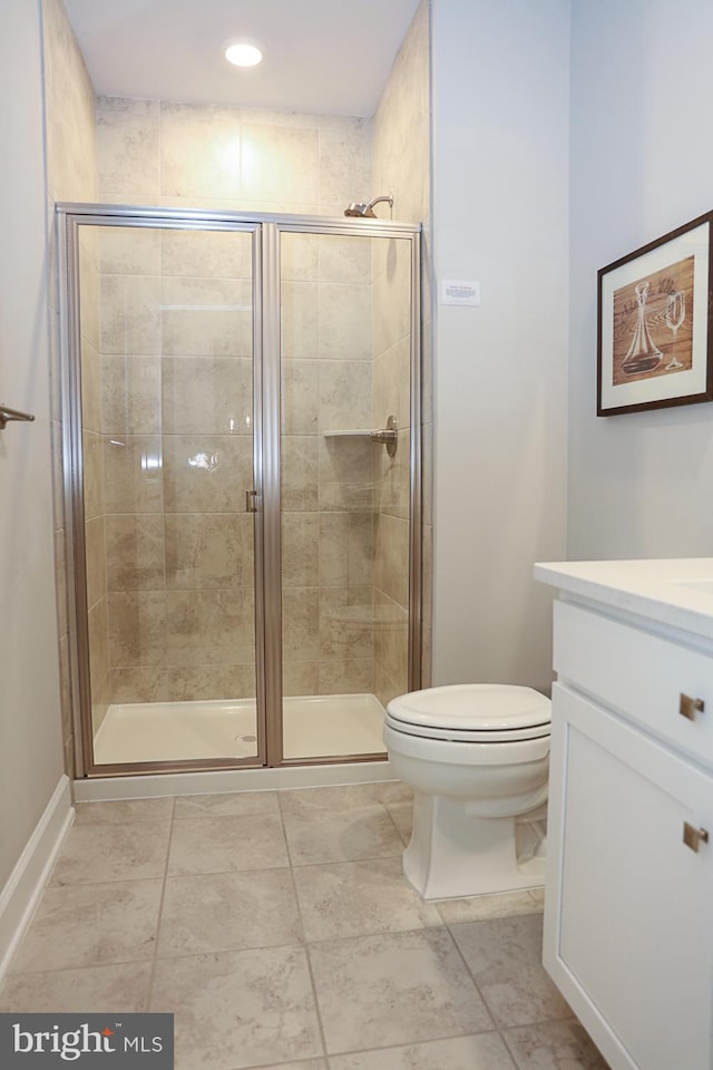 bathroom with toilet, a shower with door, and vanity