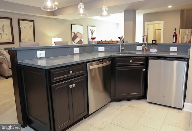 kitchen featuring pendant lighting, sink, and stainless steel dishwasher