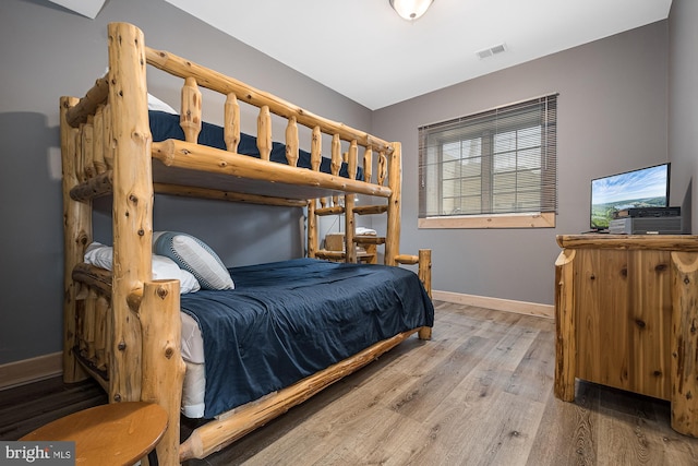 bedroom with wood-type flooring