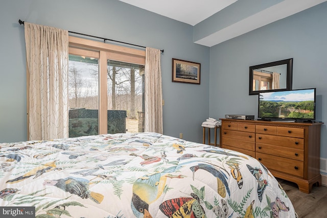 bedroom featuring wood-type flooring and access to outside