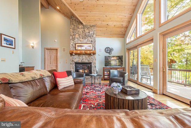 living room with high vaulted ceiling, a stone fireplace, light hardwood / wood-style floors, and wood ceiling