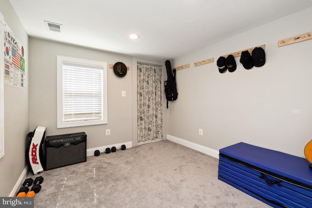 workout area featuring light colored carpet